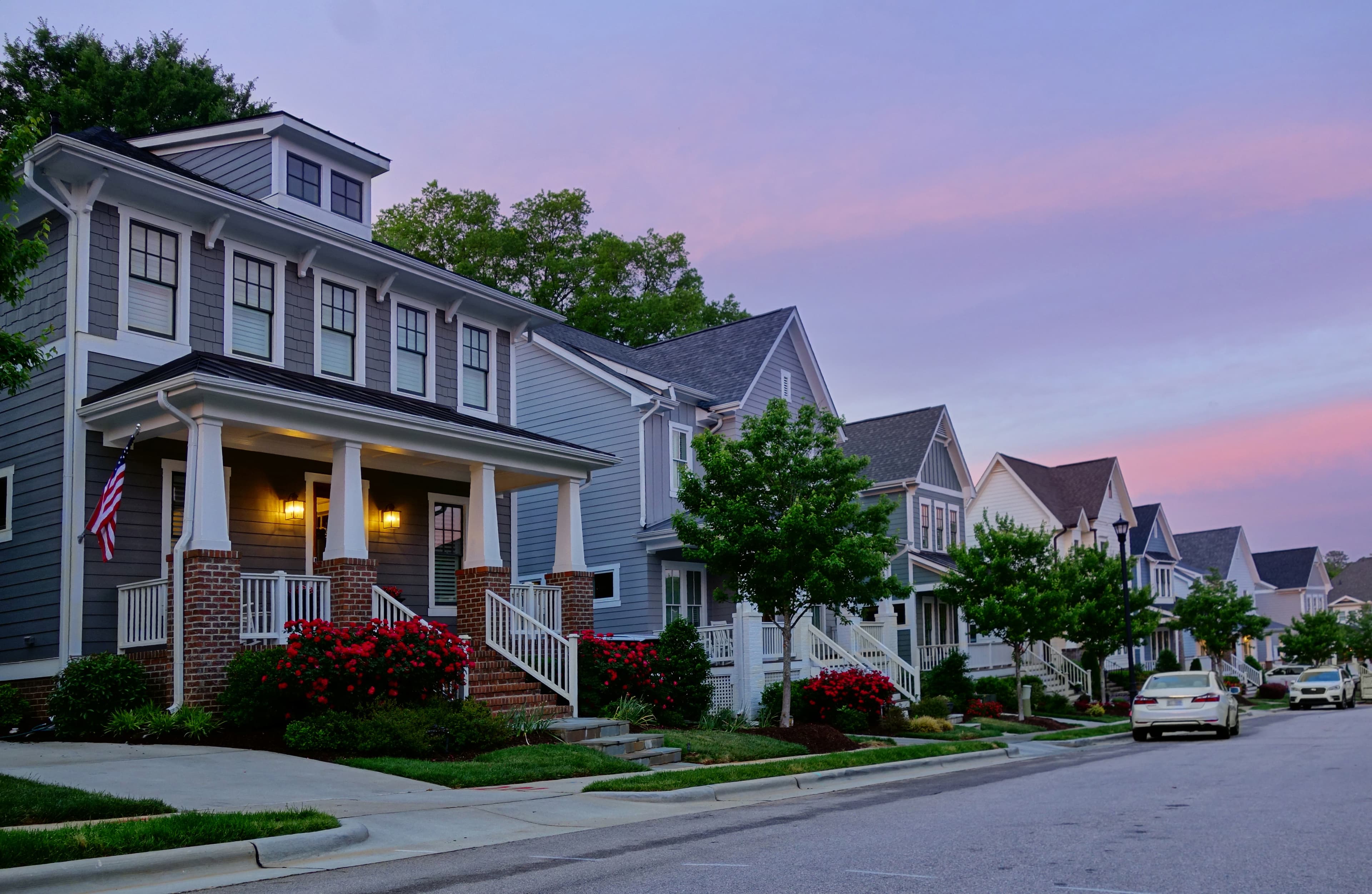 Group of homes next to each other with a sunset in the back